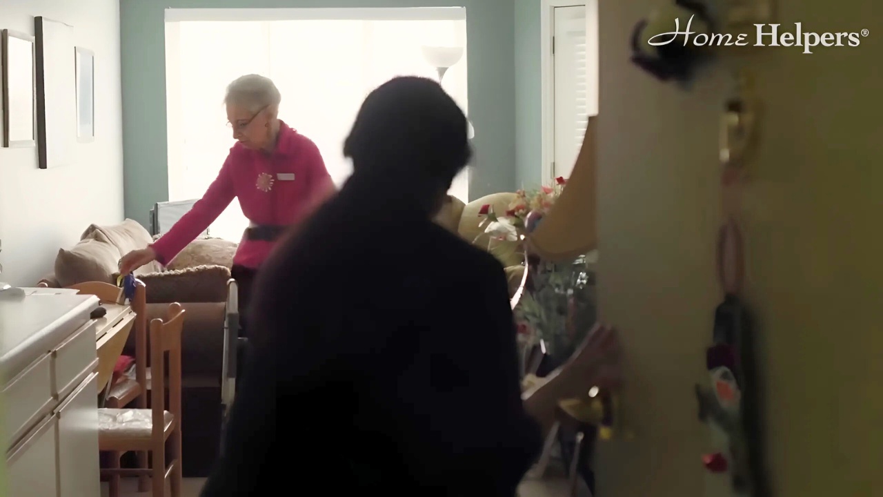 Caregiver assisting senior woman, new resident into transitioning ot assisted living.