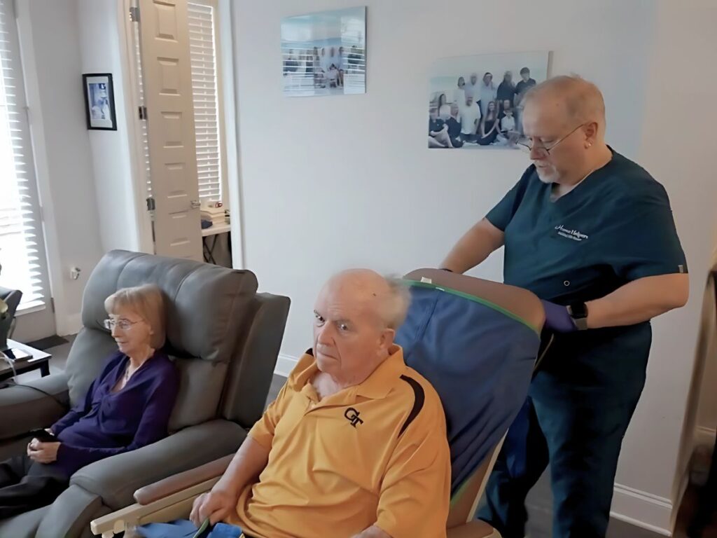 Male caregiver pushing client's chair