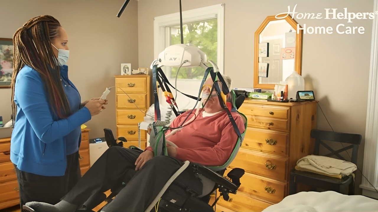 Caregiver helping her senior client with a machine for breathing.