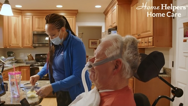 Caregiver preparing meals for her senior client at home.