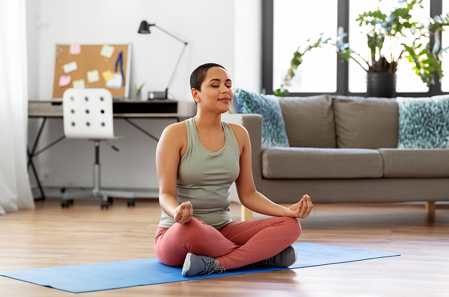 A family caregiver meditating during family caregivers month.