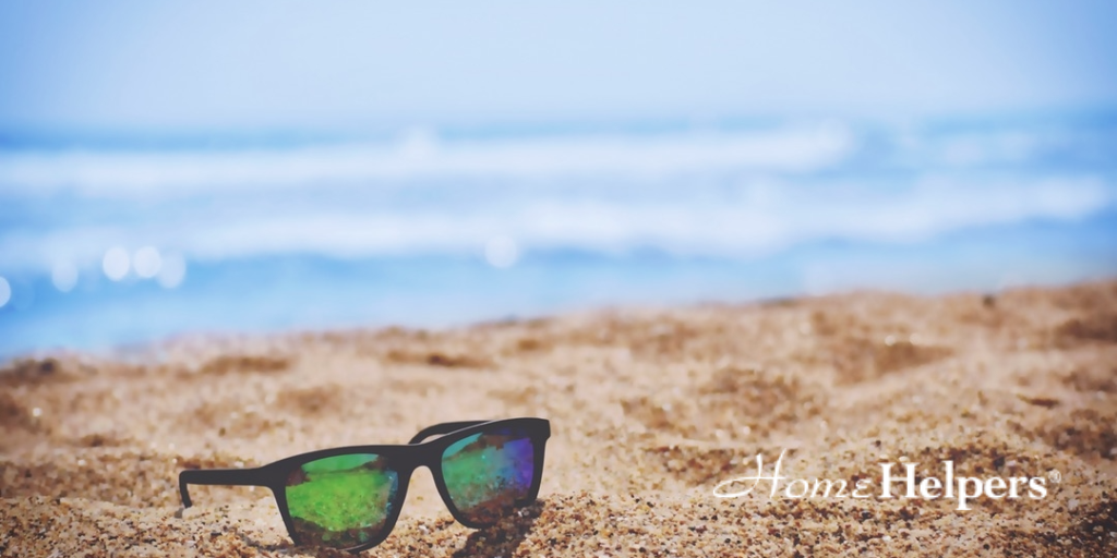 Sunglasses placed on the beach sand