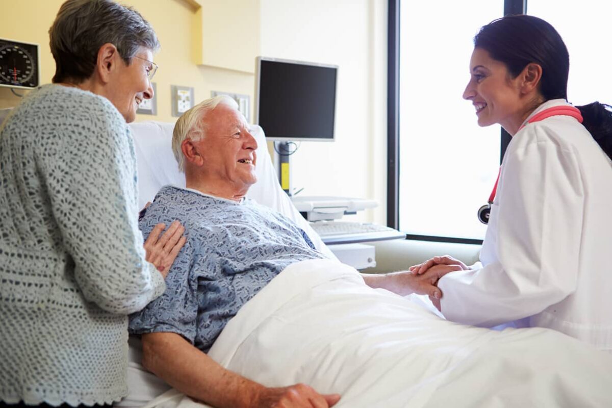 Doctor in a hospital helping seniors with recovery from a heart attack.