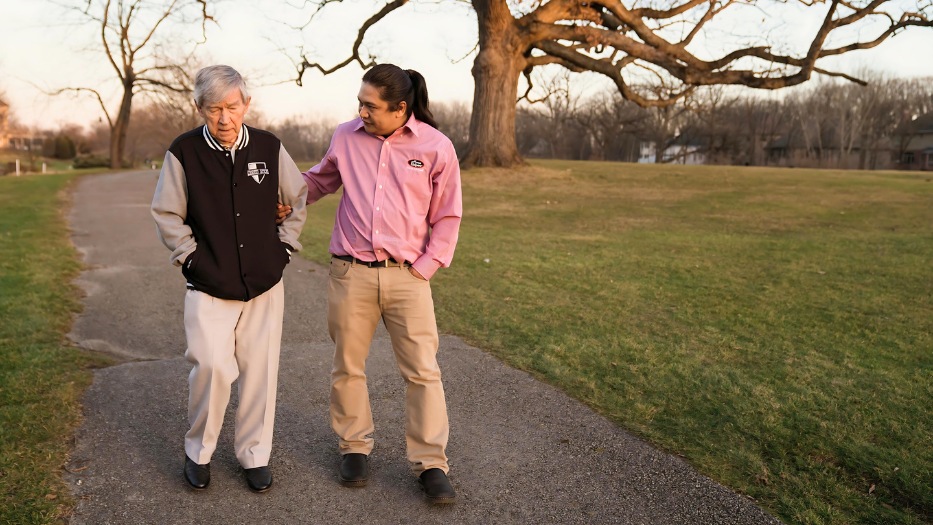 Caregiver and senior client walking together