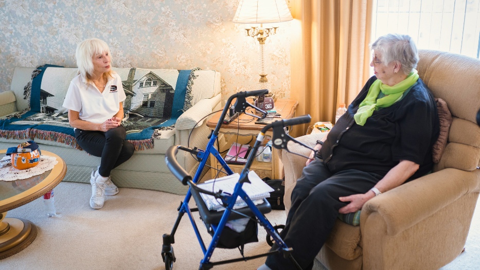 Home Helpers caregiver talking with senior client at home.