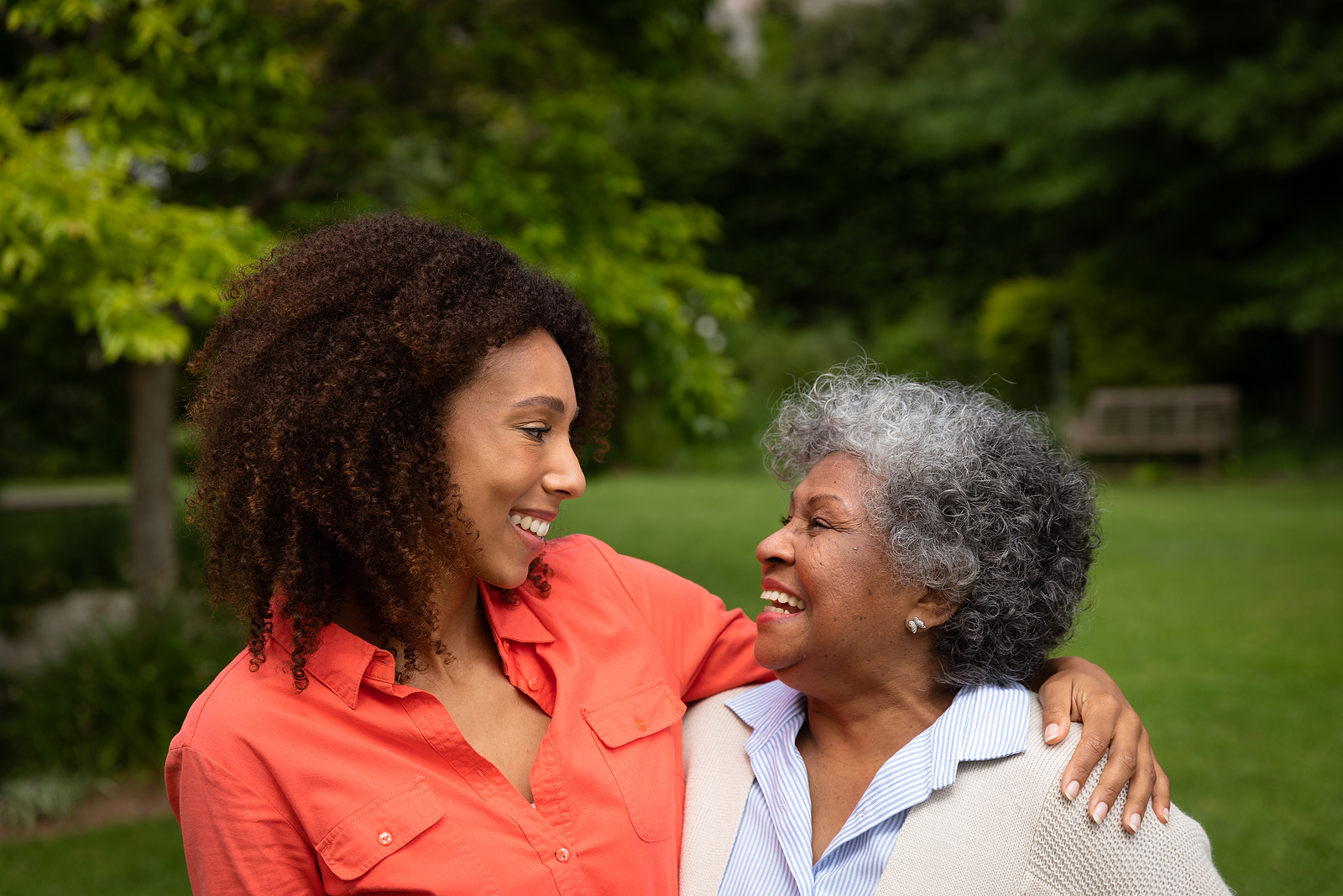 Side view of senior hugging family member
