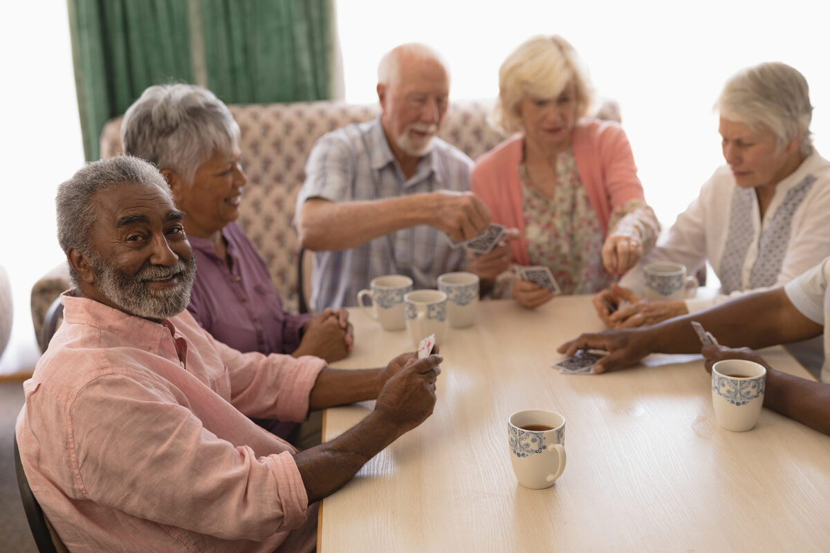 Front view of a group of seniors playing cards together