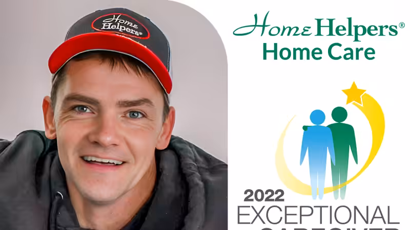 A man wearing a red and black Home Helpers cap smiles. Next to him is the Home Helpers Home Care logo and a graphic reading 2022 Exceptional Caregiver with two figures and a gold star.