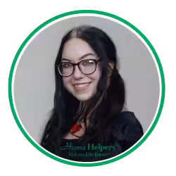 A smiling woman with long dark hair and glasses, wearing a black top and a red necklace, is shown in a circular frame with a green border. The words “Home Helpers Making Life Easier” appear at the bottom.