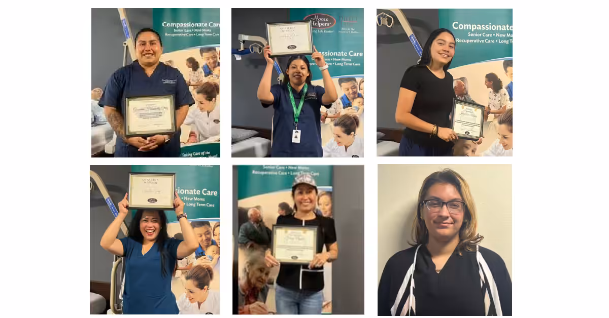 Six people pose with certificates; five are holding certificates and standing in front of a banner related to compassionate care, while one stands against a plain wall, smiling.