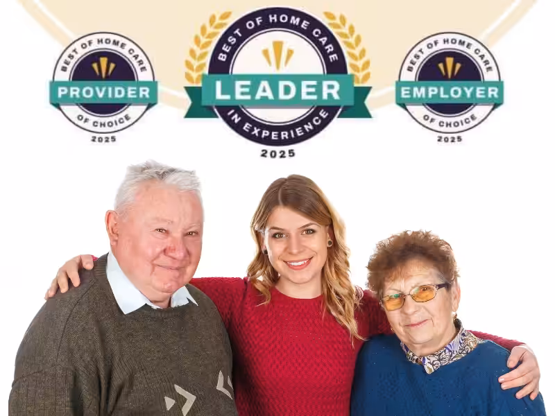 A smiling young woman stands with her arms around an elderly man and woman. Above them are three award badges labeled Best of Home Care 2025: Provider, Leader in Experience, Employer of Choice.