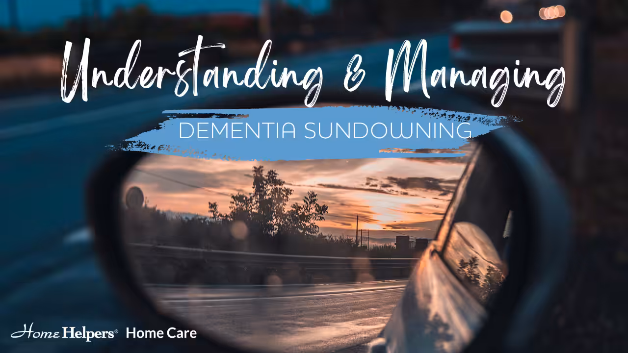 A car side mirror reflects a sunset over a road, with text overlay: Understanding & Managing Dementia Sundowning. The Home Helpers Home Care logo appears in the corner.