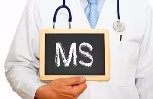 A doctor in a white coat with a stethoscope holds a small chalkboard displaying the letters MS.
