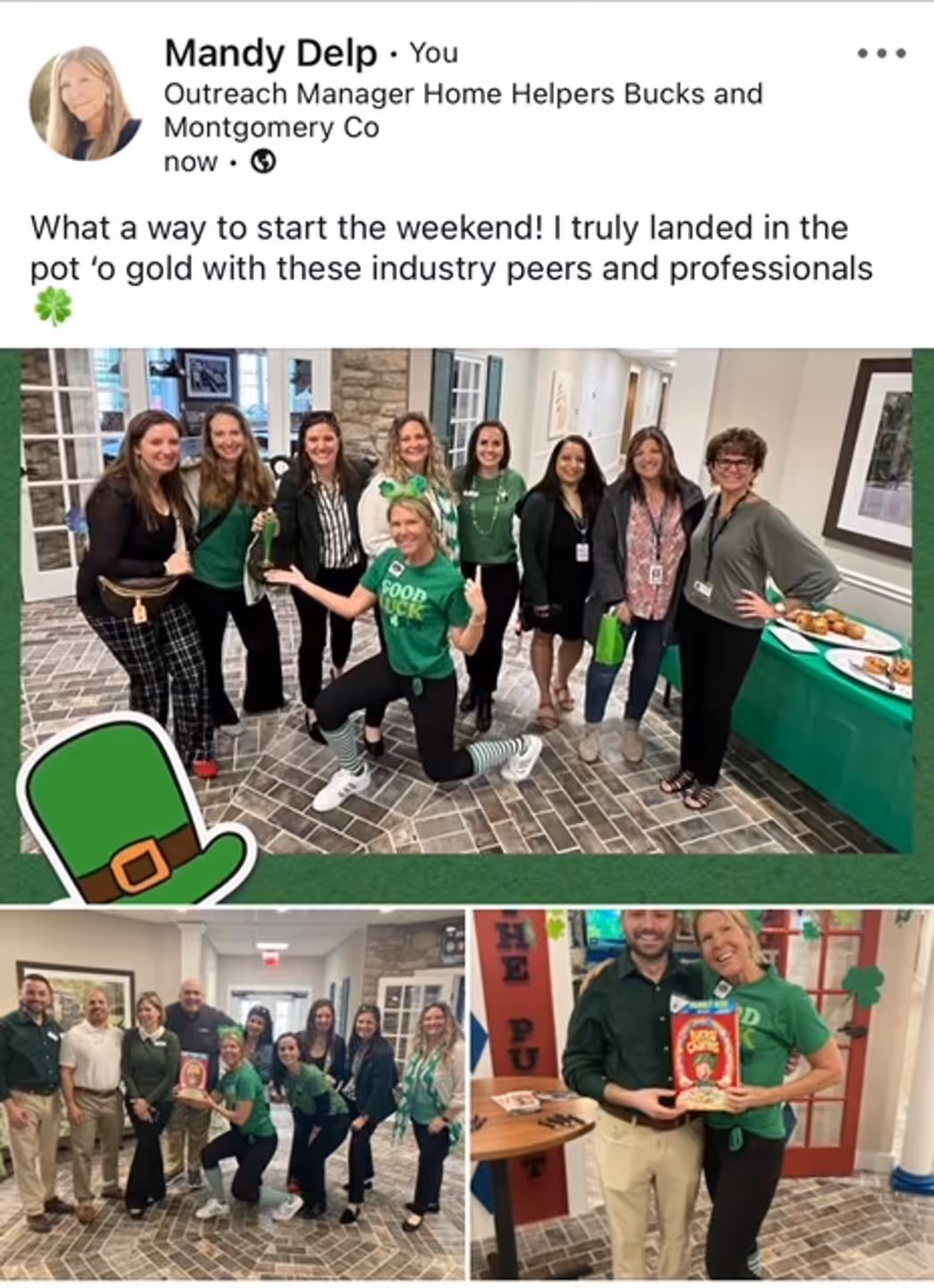 A group of people dressed in green, some holding shamrocks, pose and smile together in an indoor setting decorated for St. Patrick’s Day. A table with snacks and a green cloth is in the background.