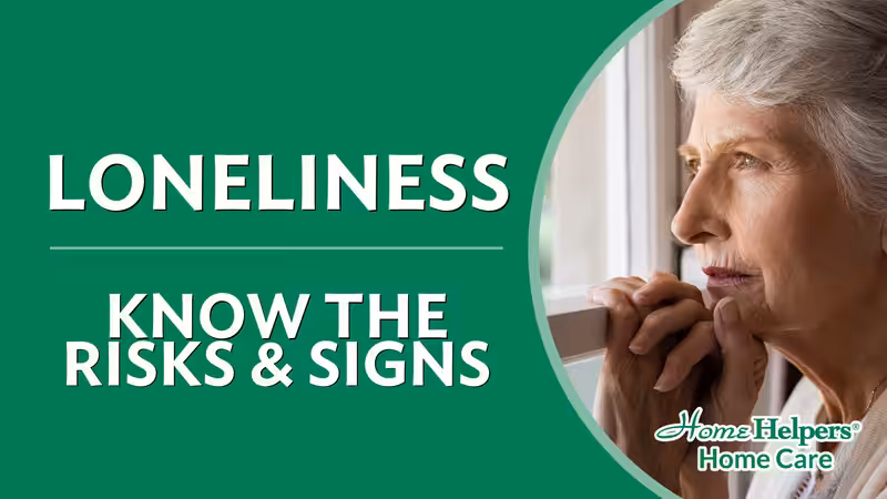 Elderly woman looking out a window thoughtfully, with text reading Loneliness: Know the Risks & Signs and the Home Helpers Home Care logo.