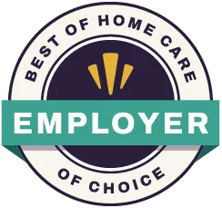 A circular badge with the words Best of Home Care Employer of Choice and a green banner across the center that says Employer. Three gold shapes are above the banner on a dark background.