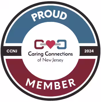 Circular badge with blue and burgundy sections, reading Proud Member. Center has a heart linked by two chain links and the text Caring Connections of New Jersey. Side text: CCNJ and 2024.